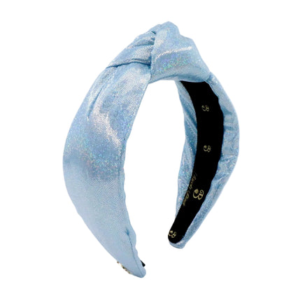 A light blue glittery fabric headband with a twisted knot design, displayed on a clean white background.