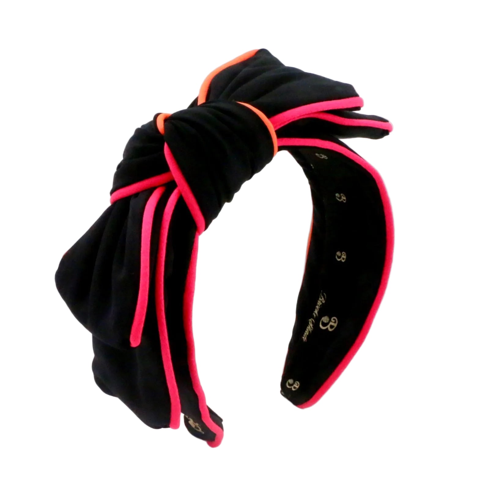 A black neoprene bow headband with vibrant hot pink and orange piping details, shown on a clean white background.