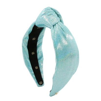 A light blue metallic glitter knotted headband with a black adjustable inner band and gold snap buttons, shown on a white background.