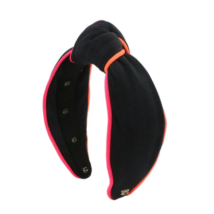 Black headband with pink interior on a white background
